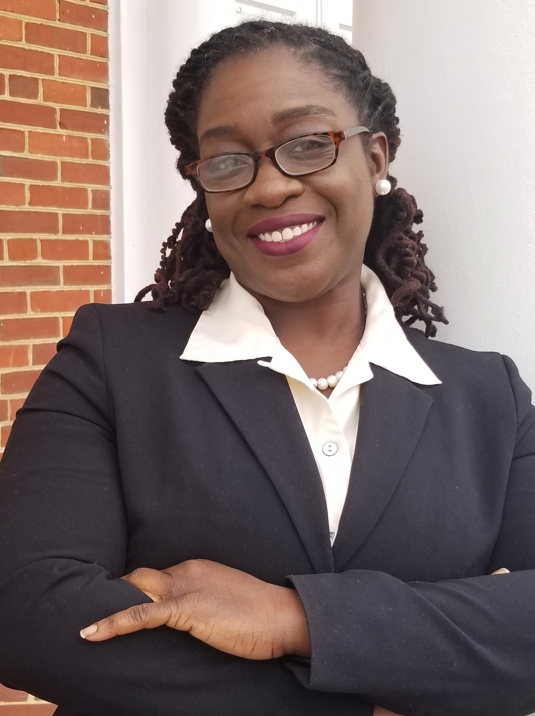 Portrait of the founder of Sankofa Services LLC, smiling warmly